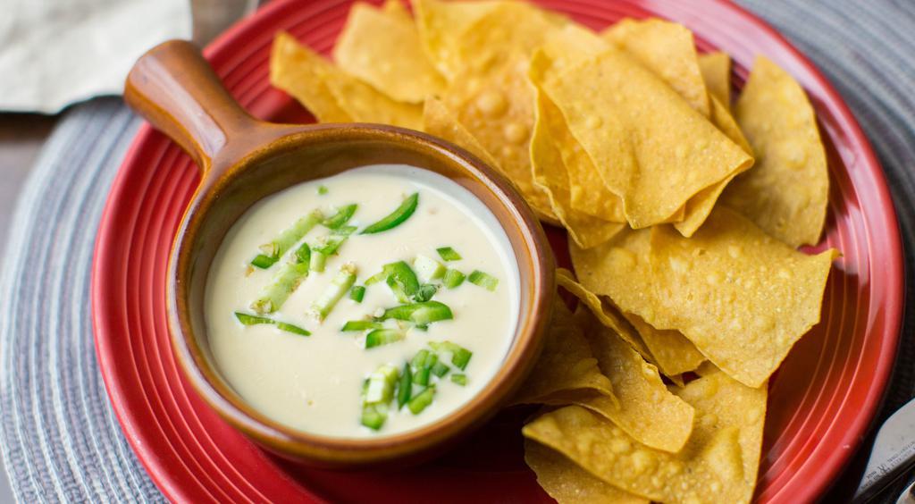 Warm Jalapeño Cheese Dip · Gluten-free. Spicy chile dusted tortilla chips.