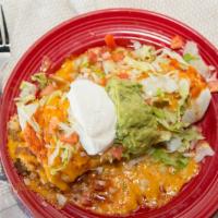 Macho Burrito · Choice of shredded chicken, shredded beef or ground beef; traditional sauce, Spanish rice, r...