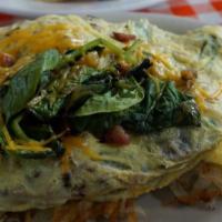 Veggie Omelette* · Sautéed spinach, tomatoes, onions, mushrooms and bell peppers and Cheddar cheese.