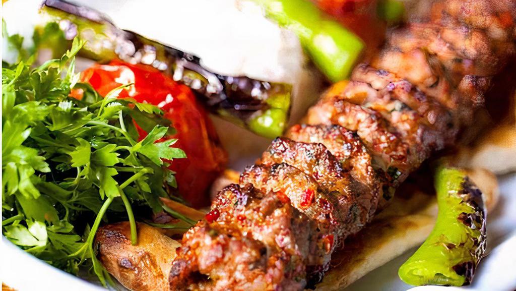 Kebab Beef And Lamb · two piece kebab over rice and salad