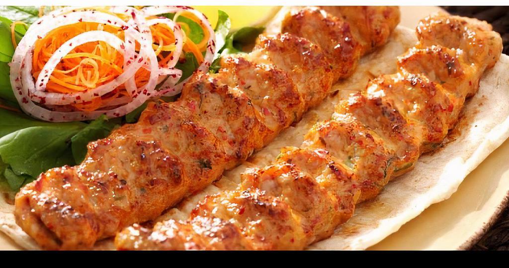 Chicken Kebab · Two piece chicken kebab over rice with salad