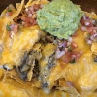 Personal Nacho · Personal sized nacho with our homemade corn chips, pinto beans, cheese blend, olives, pico d...