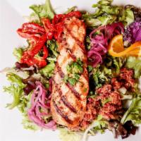 Grilled Salmon Salad · Fresh Atlantic salmon filet, feta, pickled red onion, candied almonds, and spring mix served...