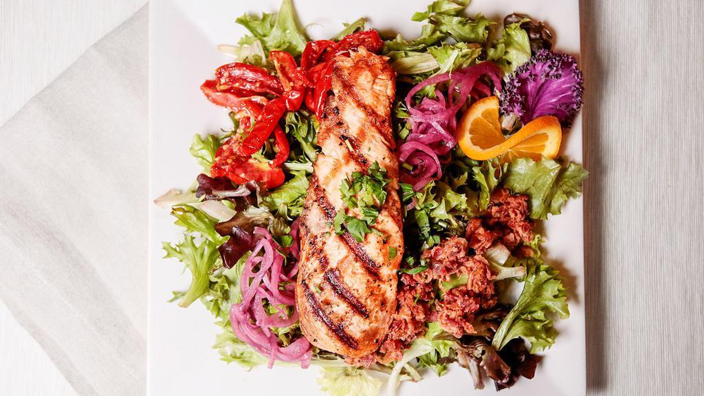Grilled Salmon Salad · Fresh Atlantic salmon filet, feta, pickled red onion, candied almonds, and spring mix served with a blackberry vinaigrette