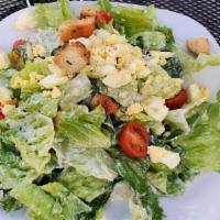 Traditional Caesar Salad · Romaine lettuce tossed with Parmesan, diced hard boil egg, tomatoes, and croutons.