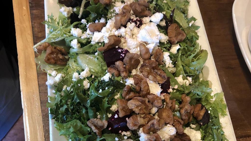 Roasted Golden Beet Salad · Roasted red beets, served on a bed of mixed greens, goat cheese, pickled red onion, and candied walnuts.  Served with our house made balsamic dressing