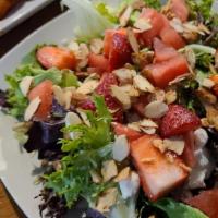 Strawberry Watermelon Salad · Fresh strawberries and watermelon on a bed of mixed greens with feta, candied almonds, sprou...