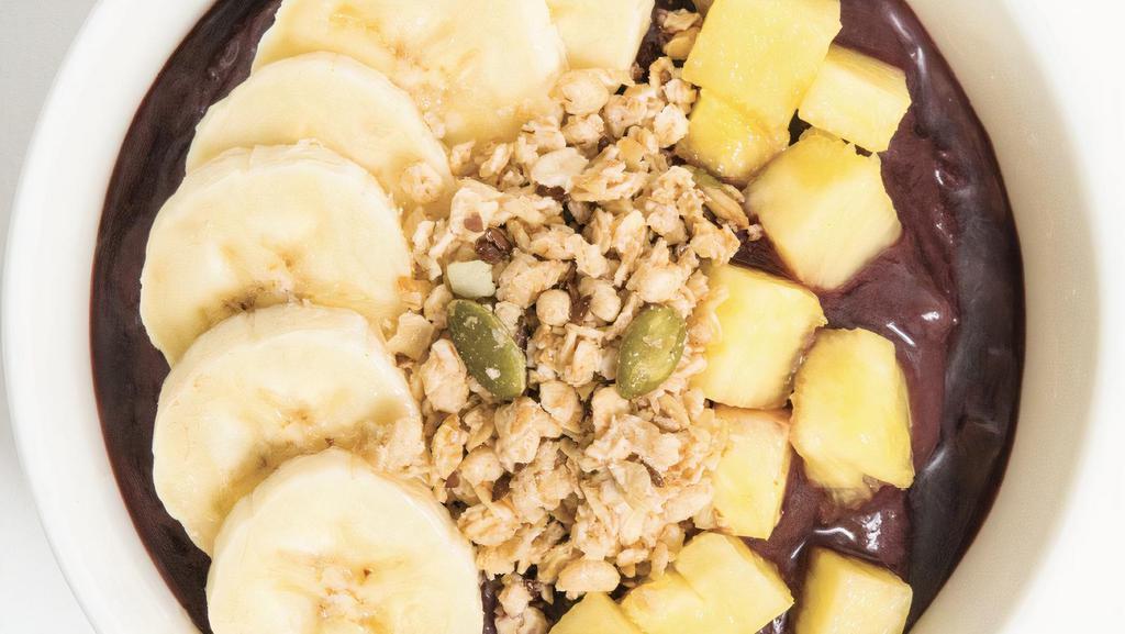 Tropical Acai Bowl · Base blend: acai, cream of coconut, blueberries, banana. Topped with: granola, banana and pineapple. Extra toppings for an additional charge.
