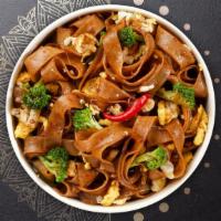 Pad Kee Mow · Stir fried flat noodles, eggs, basil, bell peppers, onions, broccoli, and carrots with garli...