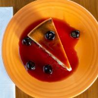 New York Cheesecake · Tall, dense cheesecake with marinated amaretto cherry sauce.