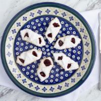 Kolacky Cookies (6 Pc) · Delicate cream cheese cookie with fruit filling and dusted with powdered sugar.