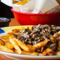Queso Steak Fries  · A bed of seasoned fries topped with steak and our famous Azteca Queso dip.