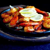 Shrimp Fajitas · Shrimp fajitas are served sizzling hot over a bed of sauteed onions and green peppers. Accom...