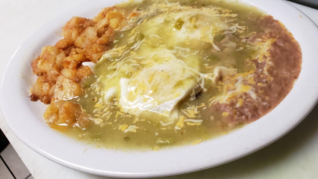 #6 Huevos Rancheros · 2 huevos sobre tortilla de maíz cubiertos con chile y queso, papas y frijoles. / 2 eggs over corn tortilla smothered with chili & cheese, potatoes & beans
