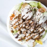 Gyro Salad · Our Greek salad topped with lamb and beef gyro meat with a side of tzatziki.