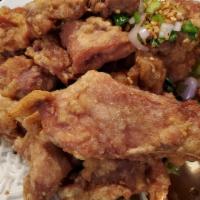 Salt & Pepper Pork Chop · Deep-fried sliced pork chop with bone tossed in jalapeño, onions, and pepper with crispy fri...