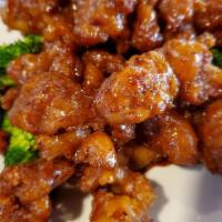 Mandarin Crispy Beef · Deep-fried sliced beef tossed in a dark classic mandarin sauce with steamed broccoli underne...