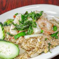 Green Curry Fried Rice · Stir-fried rice with green curry, onion, bell peppers, peas, carrots, basil and egg.