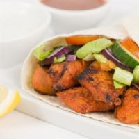 The Tandoori Chicken Wrap · Exquisite tandoori chicken grilled and marinated to perfection with customer's choice of sau...