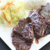 Beef Ribs · Served with rice and salad.