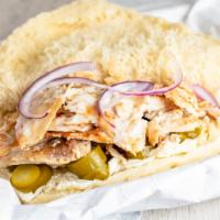 Chicken Shawarma Sandwich · Pickles, tomatoes and garlic sauce. Includes romaine lettuce and red cabbage in a pita.