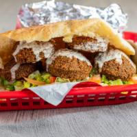 Falafel Sandwich · Vegetarian. Crispy handmade balls of ground chickpeas, mixed with fresh herbs and spices. Wi...