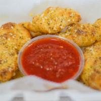 Garlic Knots. · HOMEMADE DOUGH TIED IN KNOTS
BRUSHED W/ GARLIC BUTTER, ITALIAN
HERBS, & GRATED PARMESAN CHEE...
