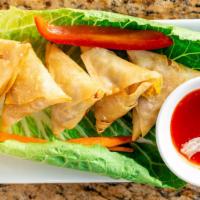 Mini Samosa · Sautéed cabbage and carrots are stuffed in phyllo pastry and deep fried serve with chutneys.