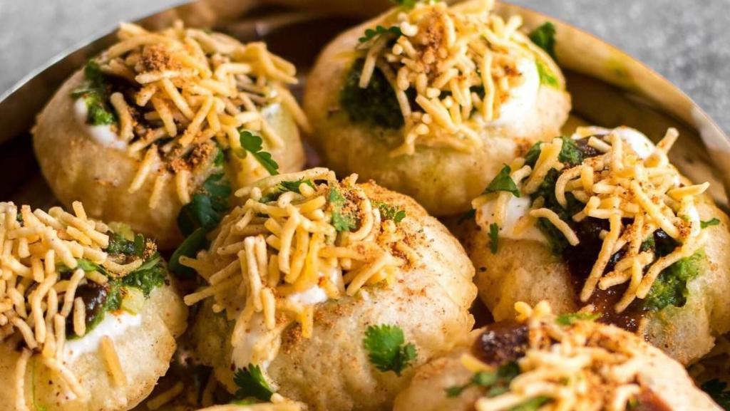 Pani Puri · Treat of Mumbai, Crispy parcels filled with spiced potato & peas  served with aromatic pani, a touch of chilli.