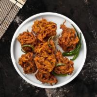 Over Onion Bhaji · House fried onions dipped in a spicy chickpea batter and fried to perfection