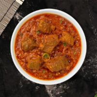 Greatest Goat Curry · Bone in goat meat cooked in mild spicy caramelized onion sauce.