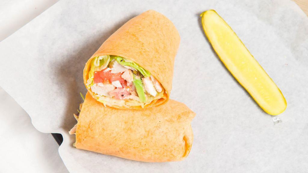 Southwest Wrap · Our Baked Chicken, Chopped Romaine, Red Onion, Tomato, Avocado and our Southwest Sauce on a Tomato Tortilla.