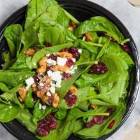 Small Sweet Leaf Salad · Spinach, Dried Cranberries, Canied Walnuts and Feta Crumbles with Balsamic Vinaigrette on th...