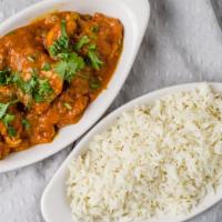 Curry Chicken · In a sauce of onions, tomato, ginger, garlic, herbs, and spices.