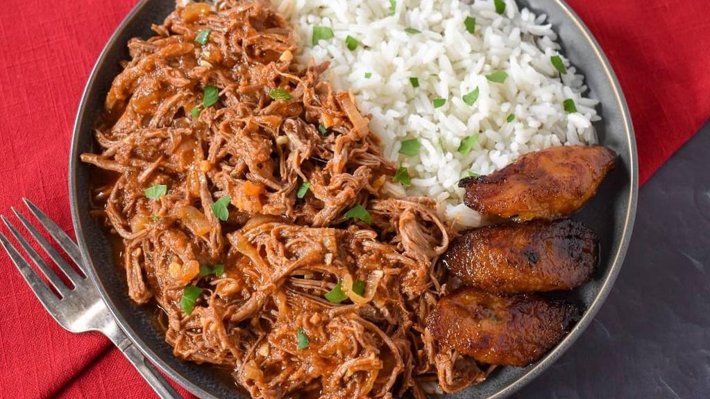 Ropa Vieja · Shredded beef in a lite red sauce cooked with green peppers and onions.