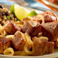 Masas De Cerdo Fritas · Fried pieces of marinated pork with grilled onions.