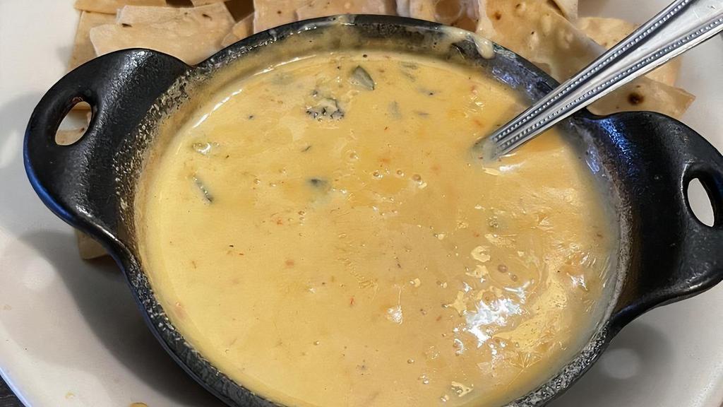 Original Con Queso Or Spinach Dip · Your choice of Original Chile Con Queso Dip or Spinch Con Queso Dip served with flour tortilla chips.