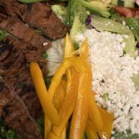 Salad Carbon · Marinated steak or chicken tenders grilled up & then layered over fresh salad greens & veggi...