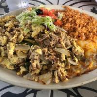 Machaca Con Huevos · Eggs scrambled with our special machaca beef (spicy! ) Includes rice, beans and your choice ...