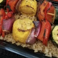 Vegetable Bento Double · Two skewers of daily cut and marinated zucchini, squash, and red onion skewers atop a fluffy...