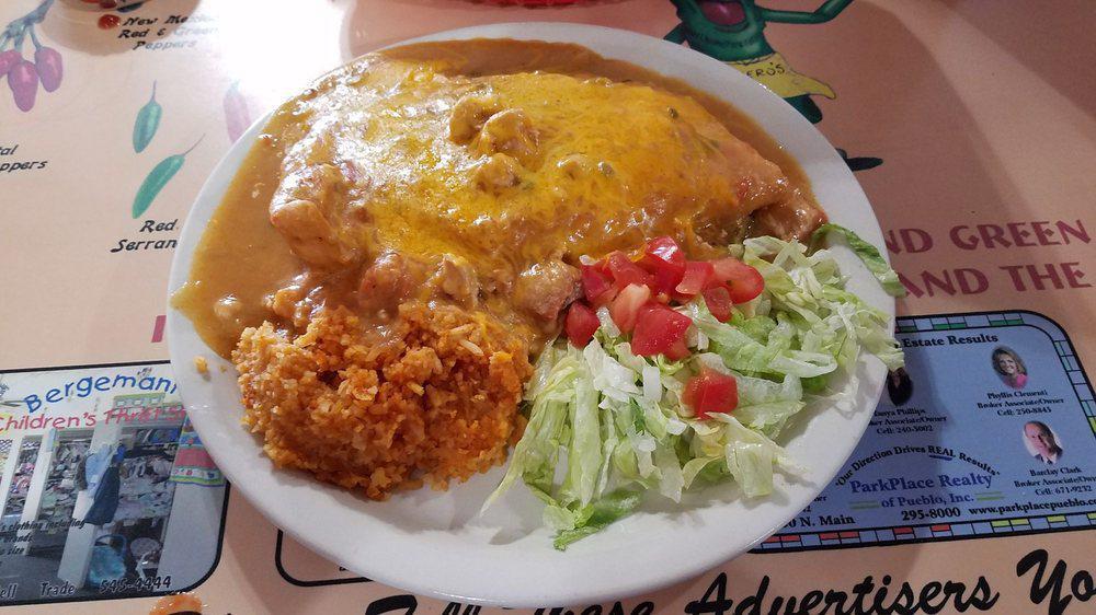 Stuffed Sopapilla · Bean stuffed Sopapilla with beef or chicken, smothered in chile with rice, lettuce, cheese and tomatoes.