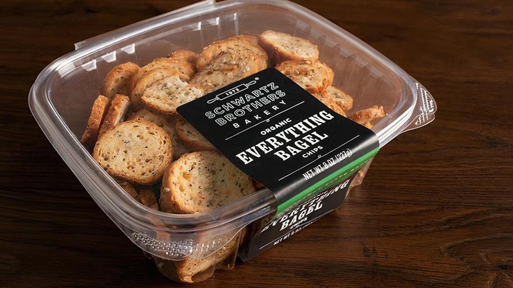 Bagel Chips - Everything · Bagel Chips - Everything.  Mixed in small batches and twice baked to achieve just the perfect crispy crunch.  Made with organic olive oil, organic garlic and organic seeds blend.  8 oz pack.  Kosher, Parve, Vegan