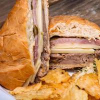 Cuban Sandwich · Slow cooked pork loin, ham, Swiss cheese, pickles, mustard, potato chips.Served with Basmati...