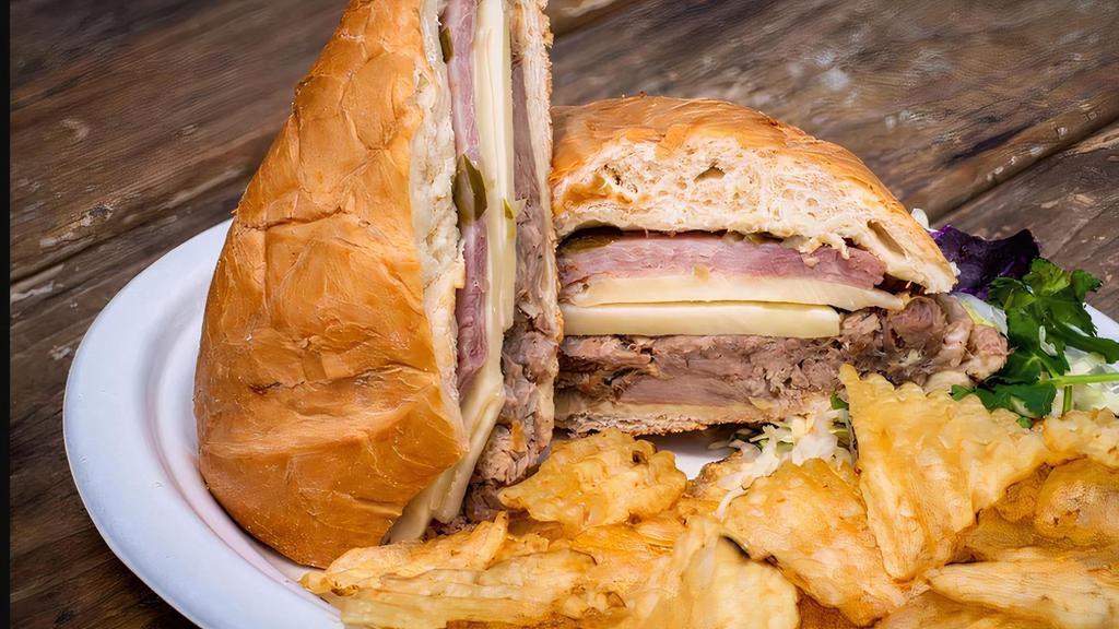 Cuban Sandwich · Slow cooked pork loin, ham, Swiss cheese, pickles, mustard, potato chips.Served with Basmati rice , Cuban black beans , coleslaw.