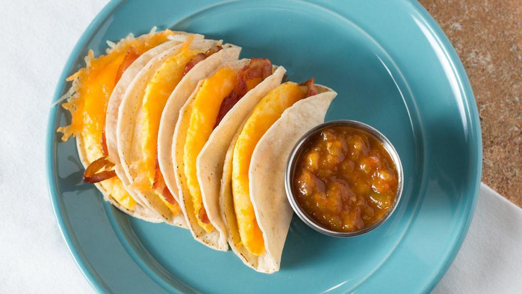 Breakfast Tacos · Four corn tortillas with egg, cheese, and choice of bacon, sausage, ham, pastrami or avocado. Served with a choice of red salsa, green salsa, or upgrade to our housemade mango salsa. Gluten-free.