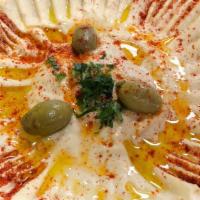 Hummus · Made from mashed chickpeas blended with garlic, tahini, olive oil, and lemon juice.
