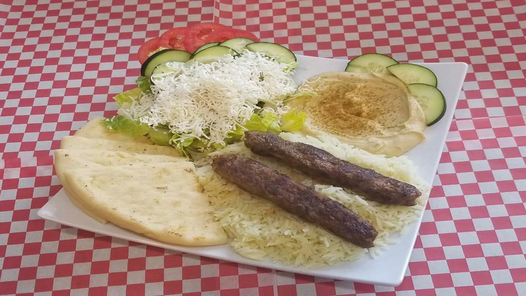 Grilled Shish Kabab Plate · Grilled ground lamb mix with onions with house spices. Served with hummus, pita, rice, and Greek salad.