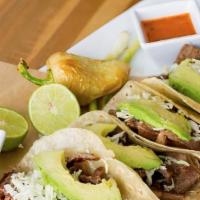 Tacos Ribeye # · Four ribeye tacos on flour tortillas, cabbage, avocado, salsa, guacamole,