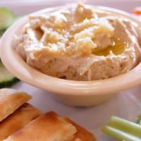 Hummus Plate · Fresh made red pepper and garlic hummus platter with cucumbers, carrots, celery and pita bre...