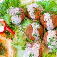 Falafel Mediterranean Plate (6 Pcs) · Seasoned ground chickpeas, deep fried salad, tahini sauce, pita bread, and hummus. Served wi...